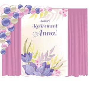 This retirement decor package includes a personalized vinyl banner, curtain backdrop, and an organic balloon arch.