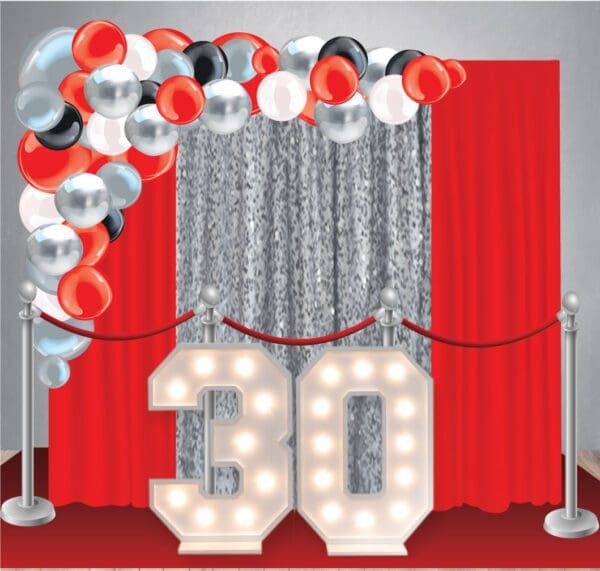 Our Birthday Decor Package 22 has a curtain backdrop, red carpet, stanchions, large organic balloon arch, and two marquee light-up numbers.