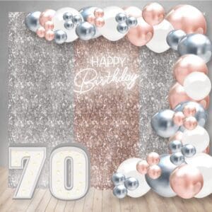 Our Birthday Decor Package 23 has a curtain backdrop, NEON sign, large organic balloon arch, and two marquee light-up numbers.